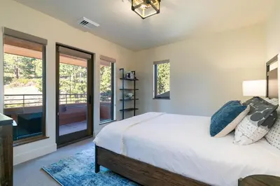 a bedroom with a bed and a balcony at Crystal Bay Penthouse 301 in Crystal Bay