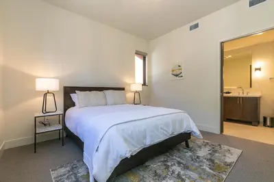 a bedroom with a large bed and a mirror at Crystal Bay Penthouse 301 in Crystal Bay