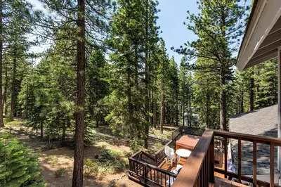 a balcony of a house with a view of the woods at Panhandle House in South Lake Tahoe