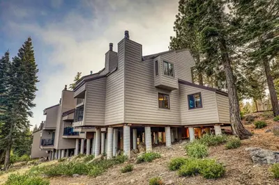 a house on top of a hill with trees at Stylish 2BD in Carnelian Bay in Carnelian Bay