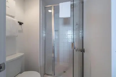 a bathroom with a glass shower with a toilet at VIP Lakefront Condo Amazing Views Pool Pickleball Excellent Location Balcony BBQ in Kings Beach