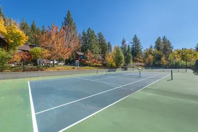 a tennis court with two tennis rackets on it at VIP Lakefront Condo Amazing Views Pool Pickleball Excellent Location Balcony BBQ in Kings Beach