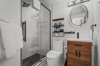 a bathroom with a shower and a toilet and a sink at Tahoe Family Friendly Home in Incline Village