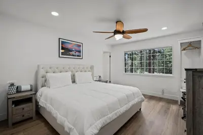 a white bedroom with a bed and a ceiling fan at Tahoe Family Friendly Home in Incline Village