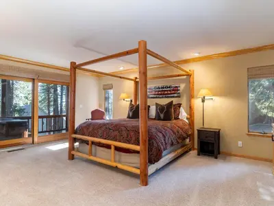 a bedroom with a wooden canopy bed in a room at Tahoe Pines, enjoy the outdoors this home has to offers in Incline Village