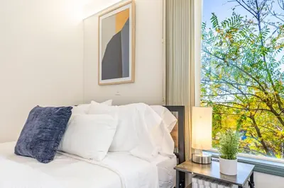 a white bed in a room with a window at Starry Night Cabin at Sky Ranch in Oakhurst