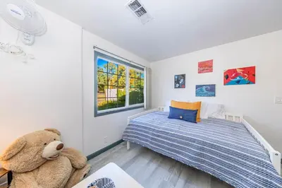 a bedroom with a bed and a teddy bear at Starry Night Cabin at Sky Ranch in Oakhurst