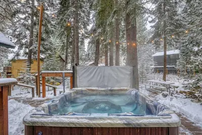 a jacuzzi tub in the snow in a yard at Serene 5BDR Near Beach and Forest Trails in Carnelian Bay