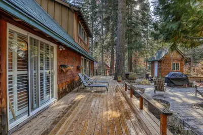 a wooden deck with benches on the side of a house at Serene 5BDR Near Beach and Forest Trails in Carnelian Bay