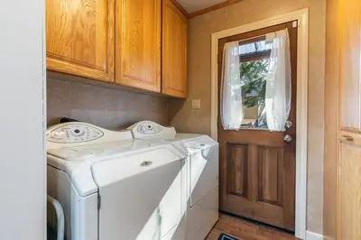 a washing machine in a laundry room with a door at Serene 5BDR Near Beach and Forest Trails in Carnelian Bay