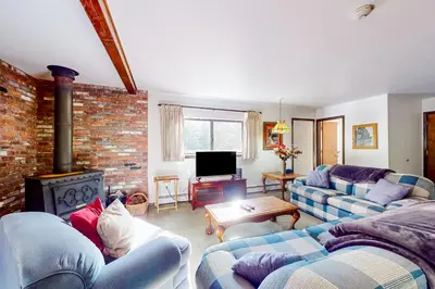 a living room with two couches and a brick wall at Antler & Pine in South Lake Tahoe
