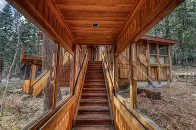 a staircase leading to a house in the woods at Sherwood Chalet - Quiet 3 BR in Ward Canyon, Private Hot Tub, Near Sherwood Chairlift in Tahoe City
