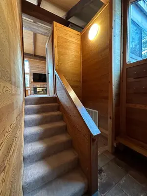 a staircase in a house with wooden walls at Lofty Retreat, Condo in Northstar in Truckee