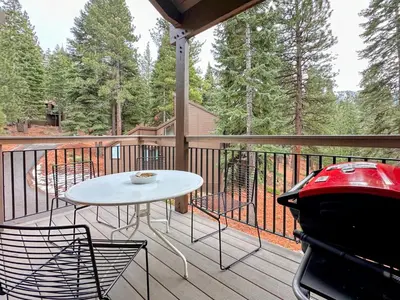 a porch with a table and chairs and a grill at Lofty Retreat, Condo in Northstar in Truckee