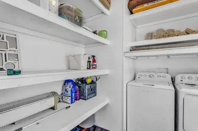 a white laundry room with a washer and dryer at Cozy Cabin on 10 acres in Pilot Hill