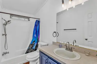 a white bathroom with a sink and a toilet at Cozy Cabin on 10 acres in Pilot Hill