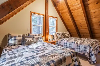 two beds in a room with wooden ceilings at North Shore - Pinetree Paradise in Tahoe Vista