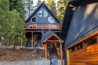 a black house with a gambrel roof with a deck at North Shore - Pinetree Paradise in Tahoe Vista
