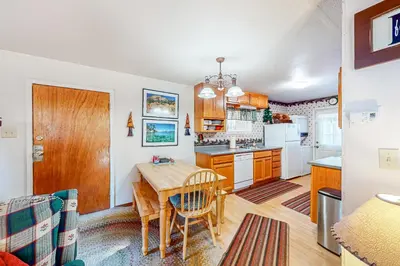 a kitchen with a table and a dining room at Pine Needle Nook in Kings Beach