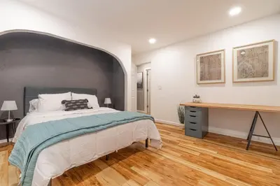 a bedroom with a large bed and a wooden desk at Vibrant Boho Home 3 Bed Pet Friendly in Reno