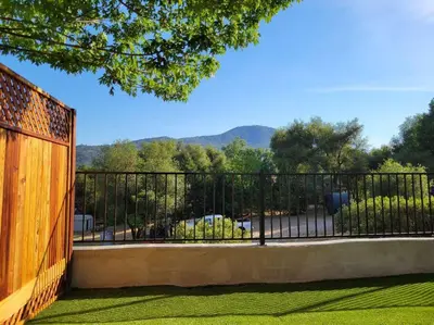 a black fence with a view of a park at Peaceful Yosemite Retreat-King Suite-Pet Friendly in Oakhurst