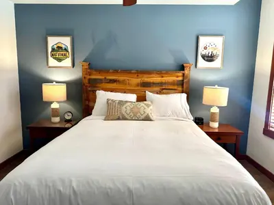 a bedroom with a large white bed with two lamps at Quiet, Updated, Corner Condo in the Village! Parking, Pool & Spa in Mammoth Lakes