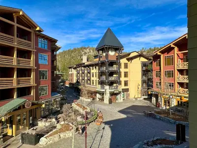 arial view of a resort with a clock tower at Quiet, Updated, Corner Condo in the Village! Parking, Pool & Spa in Mammoth Lakes