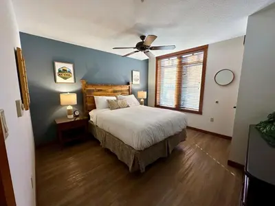 a bedroom with a bed and a ceiling fan at Quiet, Updated, Corner Condo in the Village! Parking, Pool & Spa in Mammoth Lakes