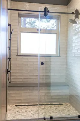 a shower with a glass door in a bathroom at Firefall Ranch Yosemite in Groveland