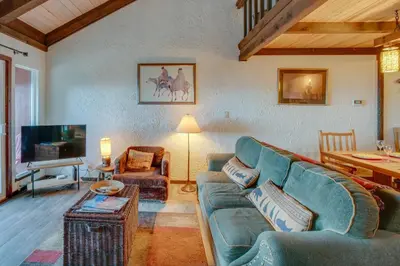 a living room with a couch and a tv at 1 Mi to Stagecoach Lift! Homey Tahoe Townhome in Stateline