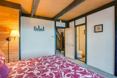 a bedroom with a purple bed and a bathroom at 1 Mi to Stagecoach Lift! Homey Tahoe Townhome in Stateline