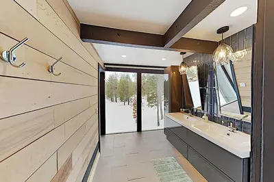 a bathroom with two sinks and a large mirror at Modern Gambrel Cabin Near Ski Resorts in Truckee