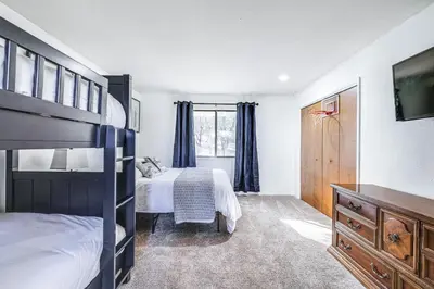 a bedroom with a bunk bed and a television in it at Groveland Home with Deck 2 Mi to Pine Mountain Lake in Groveland
