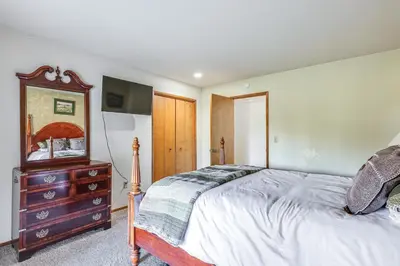 a bedroom with a bed and a dresser and a television at Groveland Home with Deck 2 Mi to Pine Mountain Lake in Groveland