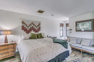 a bedroom with a large bed and a couch at Cozy Studio with Well-Being Retreat Near Yosemite! in Ahwahnee