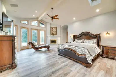 a large bedroom with a bed and a ceiling fan at Mansion, Pool, Game Room in Pollock Pines