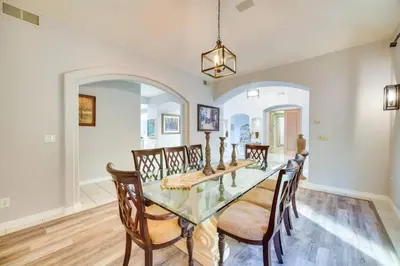 a dining room with a glass table and chairs at Mansion, Pool, Game Room in Pollock Pines