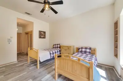 a bedroom with two beds and a ceiling fan at Mansion, Pool, Game Room in Pollock Pines