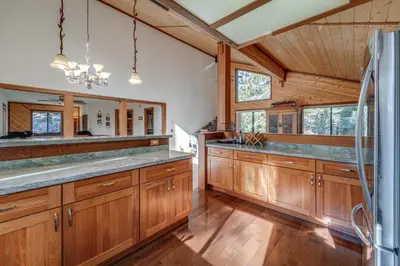 a kitchen with wooden cabinets and a large counter at Home 1 Mi to Downhill Ski Resort Bring Your Pets! in Truckee