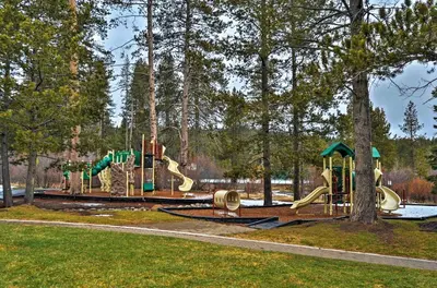 a playground in a park with a slide at Home 1 Mi to Downhill Ski Resort Bring Your Pets! in Truckee