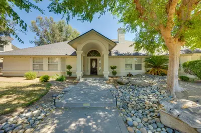 a home with a stone pathway leading to the front door at Billiards and Private Pool Bright Clovis Home! in Clovis