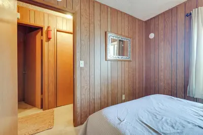 a bedroom with wood paneled walls and a bed at Strawberry Townhouse Walk to Leland Snowplay! in Strawberry