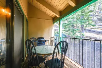 a porch with a table and chairs on a balcony at Strawberry Townhouse Walk to Leland Snowplay! in Strawberry