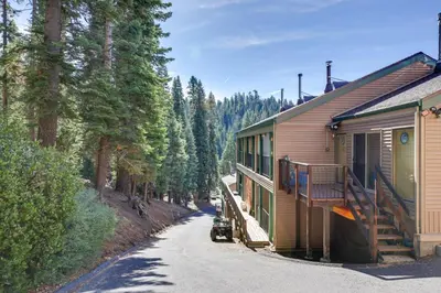 a train parked next to a building in the woods at Strawberry Townhouse Walk to Leland Snowplay! in Strawberry