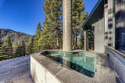a swimming pool on a balcony of a house at Open Air at Palisades - 3 BR, Brand New Construction - Wrap-Around Deck w Hot Tub in Olympic Valley