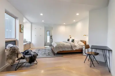 a bedroom with a dog sitting on the floor in front of a bed at Open Air at Palisades - 3 BR, Brand New Construction - Wrap-Around Deck w Hot Tub in Olympic Valley