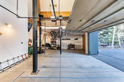 an empty garage with a ceiling with blue lines on the floor at Open Air at Palisades - 3 BR, Brand New Construction - Wrap-Around Deck w Hot Tub in Olympic Valley