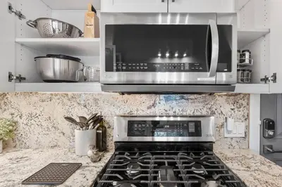 a kitchen with a microwave and a stove top oven at Tahoe Bliss: Ski, Hike, & Relax in Incline Village
