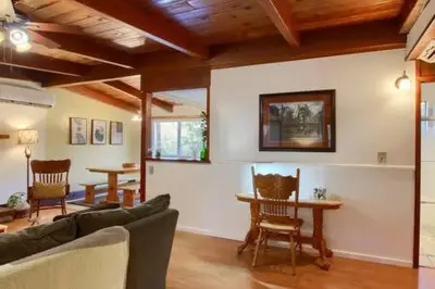 a living room with a couch and a table and chairs at Red Door Cottage Fireplace bbq 12 mi to Yosemite in Oakhurst