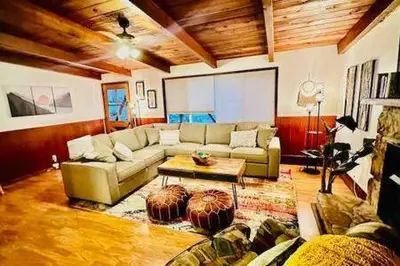 a living room with a couch and a coffee table at Orange Door Electric Fireplace bbq in Oakhurst